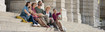A group of people wearing compression stockings sit together